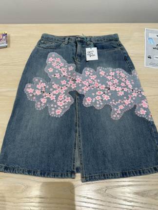 Denim skirt with cherry blossom patchwork priced at $450.
