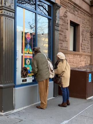 People look into a window at the Art on the Ave installment in the Upper West Side. This project was up until January 2021 and sold over $55,000 worth of art. Photo courtesy of Art on the Ave.
