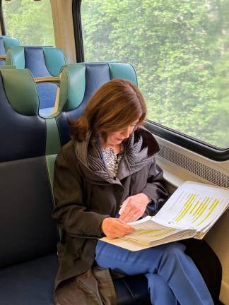 Commuters exit a Manhattan subway train during rush hour.