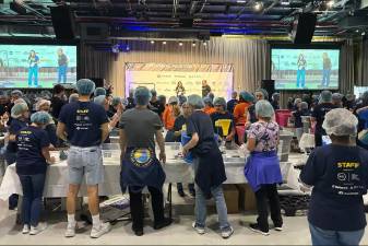 Volunteers get their marching orders for the two-day National Service Day event organized by 9/11Day.org aboard the <i>Intrepid</i> Museum.