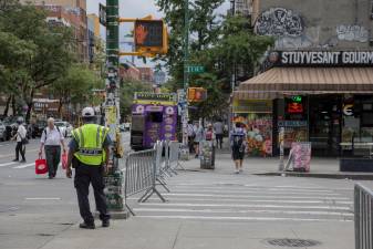 NYPD and NYC Transit officials stood by the enclosed entrance to First Avenue on 14 Street, redirecting vehicles away from the zone.