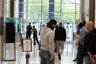 Federal agents wait in the lobby of 26 Federal Plaza to detain people after immigration hearings, May 28, 2025.