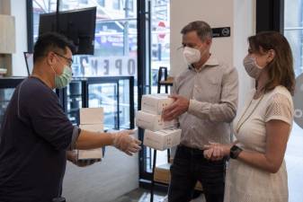 Jessica Lappin (right) and Ric Clark from Downtown Alliance handing out face masks in Lower Manhattan on June 18, 2020.