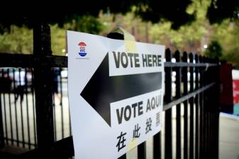 A voting sign indicates where the line begins at the Jackie Robinson Complex in East Harlem. Photo: Emily Higginbotham