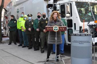 New Council Member Julie Menin (at podium) met with New York City Department of Sanitation officials on January 12 to announce the allocation of $120,000 in the city’s fiscal year budget to increase litter basket pickups in her district. Photo: Abigail Gruskin