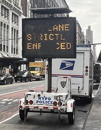 An NYPD traffic sign set near the site of a deadly crash was attempting to tell drivers that bus lane only laws were being strictly enforced, but drivers were having a hard time deciphering the warning when Chelsea News visited on Sept. 25.