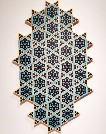 Paper cutouts become tiles, Stars of David, or anything the viewer wants to make of them in &quot;It Is He Who Created You From A Single Soul&quot; by Dana Awartani. Photo: Adel Gorgy