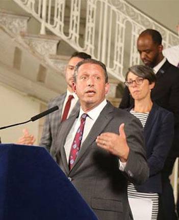 City Comptroller Brad Lander (center) has stripped Mayor Eric Adams of his emergency contracting powers when it comes to asylum seeker services, citing delays and questionable awardees. Adams called it “unfair.”