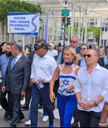 Mayor Eric Adams (center, wearing baseball cap) joins the march up Fifth Avenue.