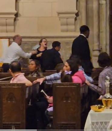 A protestor shouted “free Palestine” as he was being escorted from premises after disrupting the Easter vigil Mass at St. Patrick’s Cathedral on March 30. Photo: X (formerly Twitter)