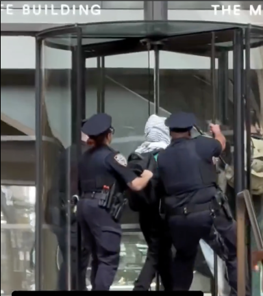 Cops stop keffiyeh man from entering MetLife Building.