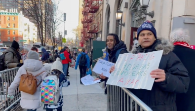 Protesters lined the entrance to the public library on East 96th Street. Photo via video footage posted by Talia Jane to Twitter