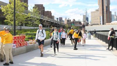 Volunteers hand out snacks to help participants refuel along the 32-mile route of the Great Saunter around Manhattan.