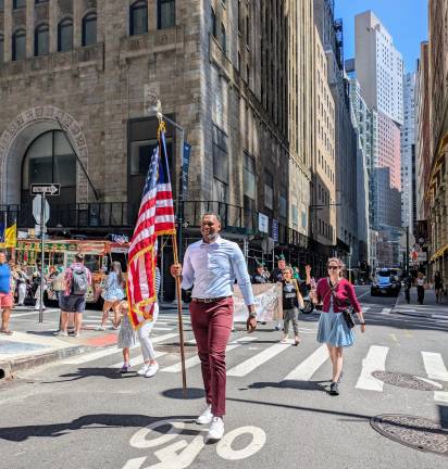 Assemblyman Small, the grand marshal, carried the American flag throughout as he led the parade around lower Manhattan.