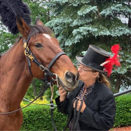 Christina Hansen and her horse King, 23, who has been a carriage horse for 19 years. Photo courtesy of Christina Hansen