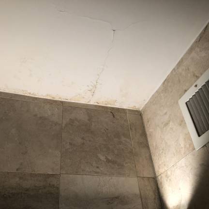 Nadine Meyers’s bathroom ceiling, where she says water from a leak in an upstairs apartment led to the growth of mold that made her sick.