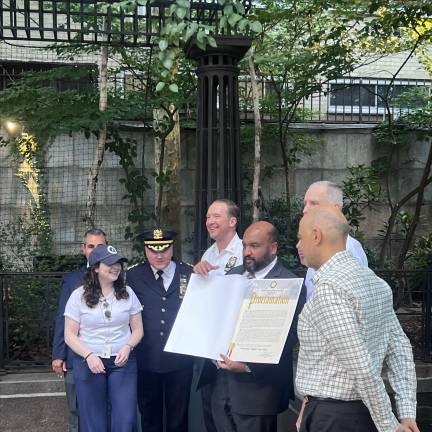 The event featured DOB Commissioner Ahmed Tigani (above, center), who praised the 17th Precinct for their assistance during the near-catastrophic collapse of the Pfizer Building last month.