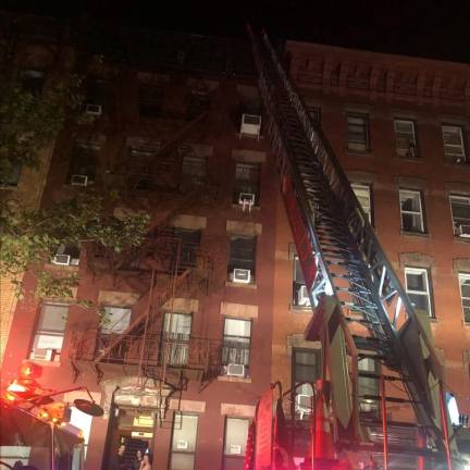 <b>A fire inside an East 7th St. apartment, which one resident said was set by someone who did not live in the building, drew about sixty firefighters to the scene on June 1</b>. Photo: Keith J. Kelly