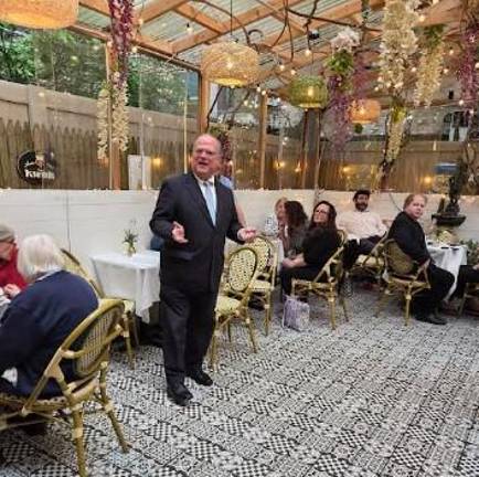 While judges don’t actively campaign in the traditional sense, they do hold “meet and greets” for delegates who pick the candidates. Here Judge Jim Clynes holds one such session at the B. Cafe on East 75th Street earlier this summer.