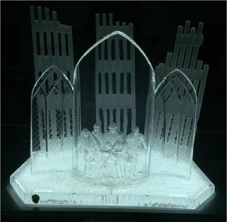 A Crystal etching based on the iconic photo taken by Reuters photographer Shannon Stapleton when five people carried the body of the fallen FDNY chaplain Father Mychal Judge out of the North Town on 9/11. It is at Engine 1 - Ladder 24 (142 W. 31st Street) Battalion 7, Division 1, across from St. Francis Assisi Church.