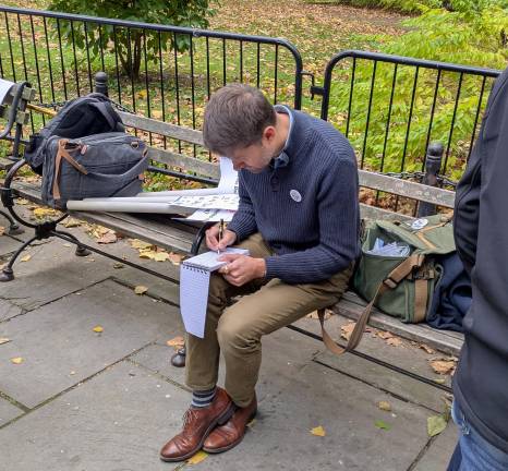 Evan Simko-Bednarksi preparing his notes before the rally.