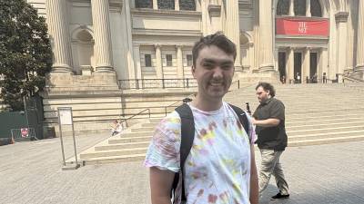 Joey Johnson, creator of the Instagram and TikTok account @<a rel=nofollow noopener noreferrer href=https://www.instagram.com/herbshotdogreviews/ target=_blank>herbshotdogreviews</a> gets ready to review a hot dog from Smash Kitchen at a pop-up to promote National Hot Dog Day. He gave it a rave review.
