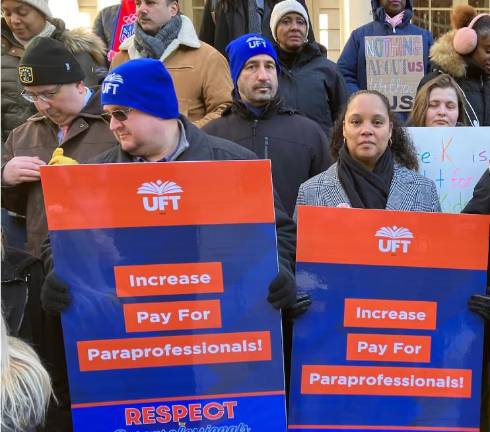 New York City teachers union members rally for paraprofessional raises in January, 2025. A bill that would grant $10,000 one-time pay bumps became law last week.