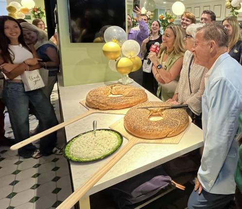 Ess-a-Bagel Celebrates 50th Anniversary with huge bagels that in were cut in lieu of a ribbon, with a pizza dish-sized platter of cream cheese adjacent. Only in New York!
