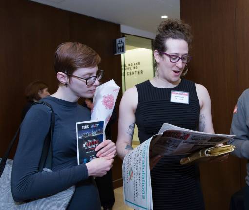 Zil Goldstein (right) reads her OTTY profile in Our Town. Photo: George Cade Photography
