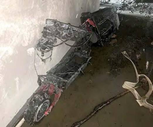 Charred scooter whose lithium ion battery ignited the conflagration on the 20th floor of an Upper East Side hi-rise tower on Nov. 5, 2022 that required a rope roof rescue of trapped victims. Photo: FDNY