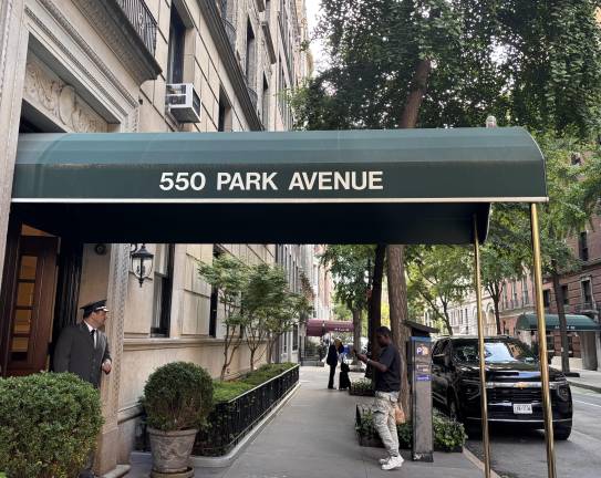 A doorman stands outside 550 Park Avenue, where property records recently listed “His Majesty the King in Right of Canada” as the seller of an $8.05 million apartment.