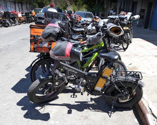 A typical day on East 11th Street between First Avenue and Avenue A, where 100s of e-bikes, scooters and mopeds take over public space on behalf of the app delivery industry.