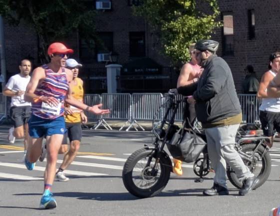 Oblivious and aggressive e-biker walks across the course, runner reacts wtf?!