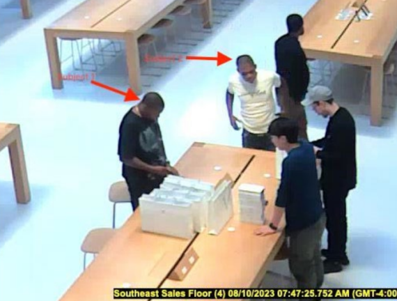Surveillance footage from an Apple Store shown by prosecutors in court, which they say depicts two of the defendants buying goods with stolen cards.
