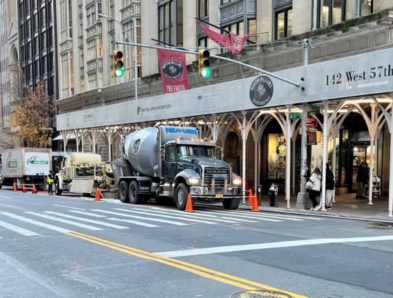 <b>The cement truck parked where a street sign notes no standing from 7AM-10AM was slapped with a summons during the crackdown by NYPD traffic staff for being illegally parked in the bus lane during the morning rush while it was mixing cement. </b>Photo: Ralph Spielman