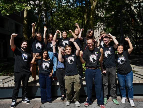 Members of the union pose after a victory to unionize with IAPE Local 1096 of the NewsGuild.