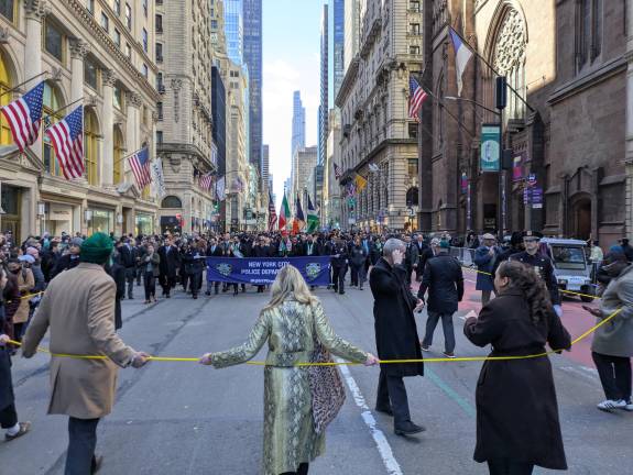 Mayor Mamdani marches behind long cordon held by his staffers while dozens of cops secure the sides and the Mayoral phalanx, including PC Tisch and Cardinal Hicks.