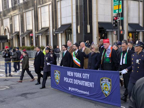 Mayor Mamdani, PC Tisch and Cardinal Hicks, photographed from the side.