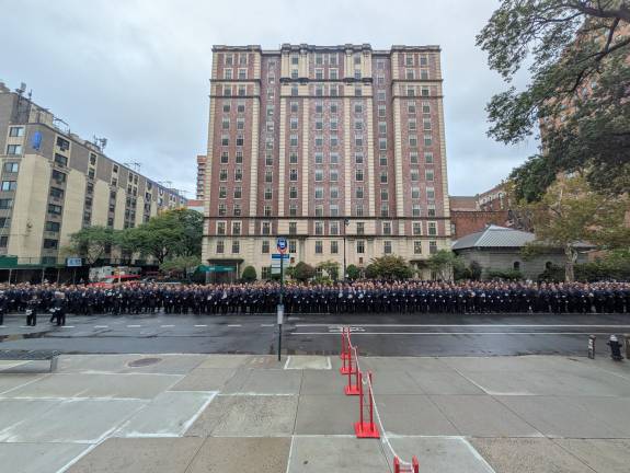 After the service proper, a memorial procession amid a sea of blue on Amsterdam Avenue.