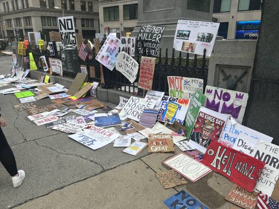 Signs left behind at the end of the “No Kings” rally.