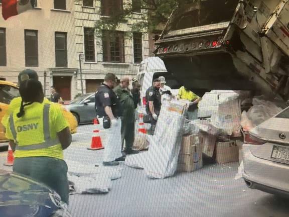 Police and sanitation workers respond to a report of what was initially believed to be human remains on East 72nd Street between Second and Third avenues. It turned out to be improperly discarded medical waste.