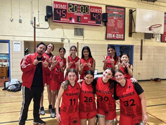<b>Coach James Marty and the Robert F. Wagner middle school girls basketball team after their come from behind victory against Tompkins Square Middle School in the quarter-final playoff game.</b> Photo: Robert F. Wagner Middle School