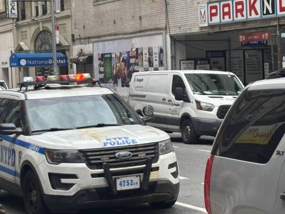 The police cruiser is parked down the street from historic St. John the Baptist Roman Catholic church on West 30th Street, near Madison Square. The lights were flashing, but no police officer was seen inside or nearby on Aug. 29.