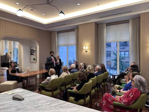 Indie party candidate Kyle Athayde (at mic) and Democratic nominee Virginia Maloney (seated at table) addressing a candidate forum held by the Sutton Area Community. Republican nominee Debra Swartzben did not attend.