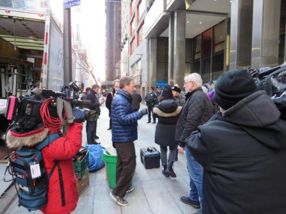 <b>As media representatives kept up with NYC Transit President Davey during the bus lane traffic enforcement blitz on December 15, a food truck driver was being told by Davey that he could not make a delivery before 10AM in the bus lane, the driver then pulled away, with the material lying on the sidewalk.</b> Photo: Ralph Spielman