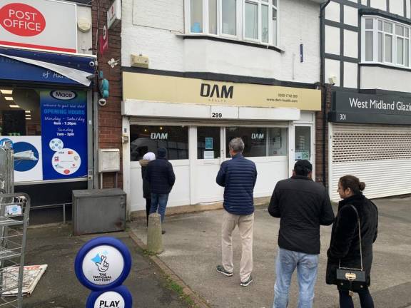 With COVID testing locations scattered throughout England, this one in suburban Birmingham offers different tests for both positivity and international travel. On a Sunday noon, there was a full waiting room inside. Photo: Ralph Spielman