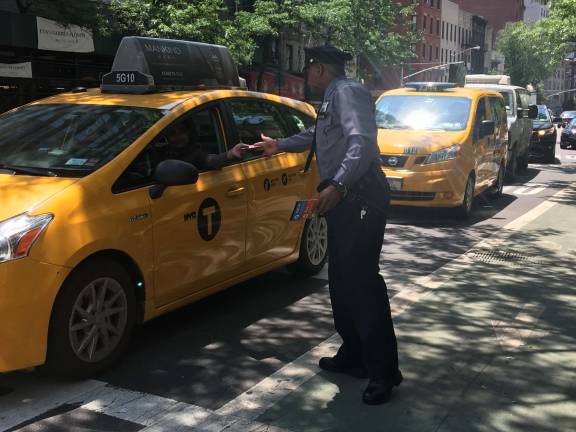 Motorists, including taxi drivers, also received the flyers. Photo: Madeleine Thompson