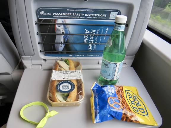 On the new trains, meal service in business class can be purchased in the cafe car or from a rolling cart that serves both food and drink.