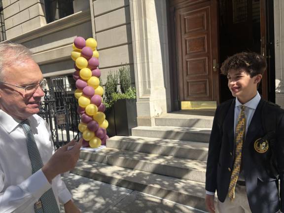 A brief catch-up on the summer with Loyola High School president Tony Oroszlany (left) and returning junior student Alex Stihi on Sept. 4, the first day of the new school year.