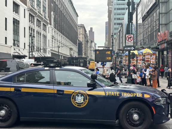 A New York State Trooper drives near 34th Street and 7th Avenue.